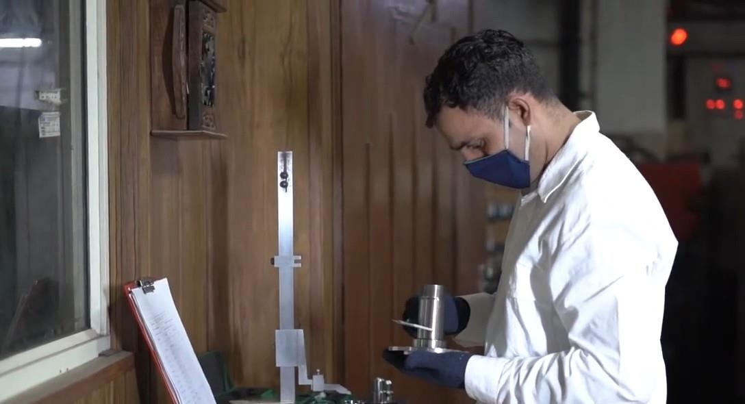 Engineer checking a machined part at Jolly Auto India