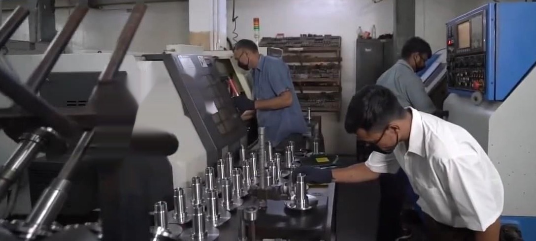 Operators at CNC machines in the machine shop