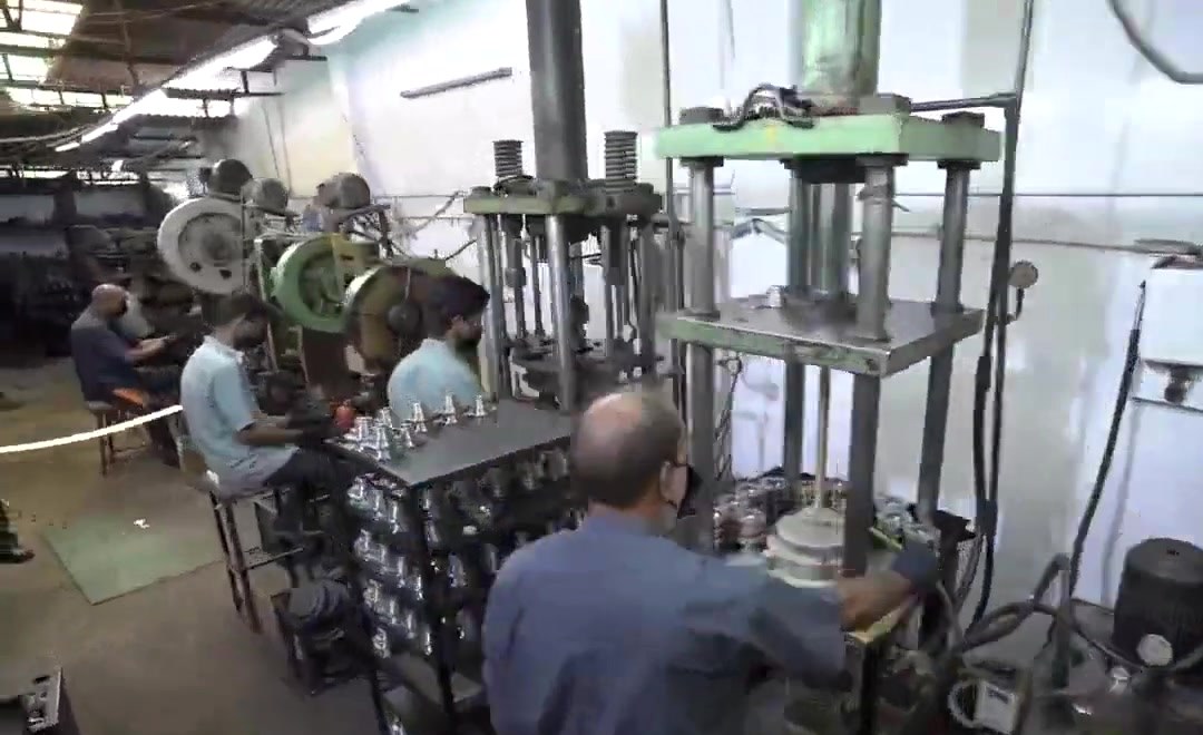 An operator at a hydraulic press